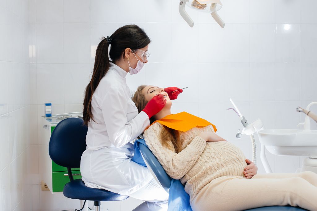 professional-dentist-treats-examines-oral-cavity-pregnant-girl-modern-dental-office-dentistry.jpg
