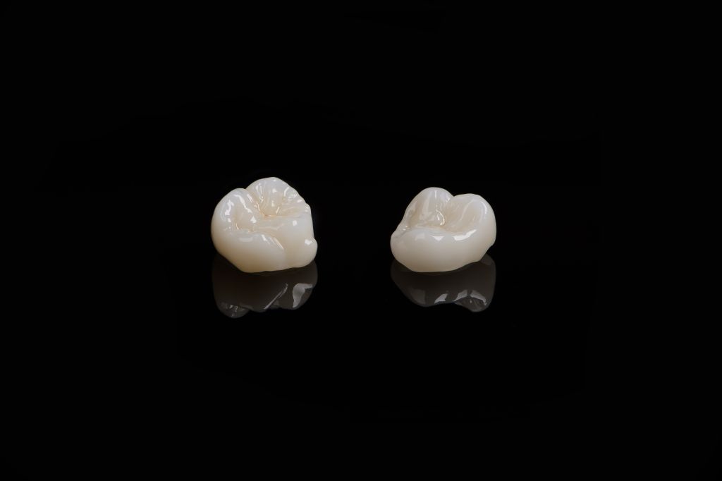 qualified-anatomic-ceramic-zirconia-crowns-human-teeth-close-up-macro-isolated-black.jpg